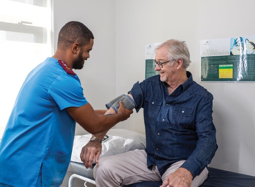 A nurse checking a resident's blood pressure at the Evergreen Healthcare Centre