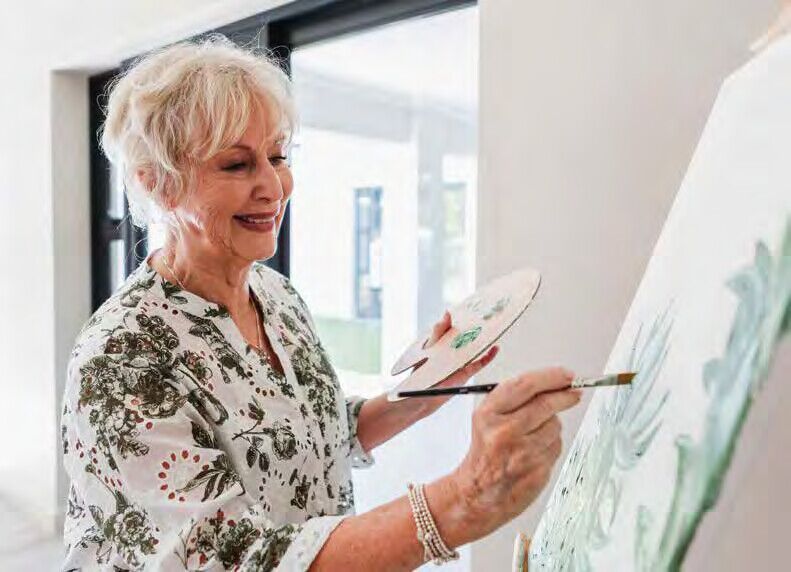A resident painting at an easel