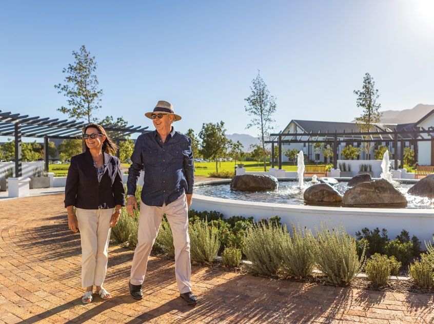 A couple walking through the village garden